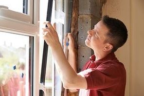 Construction Worker Installing New Windows In House